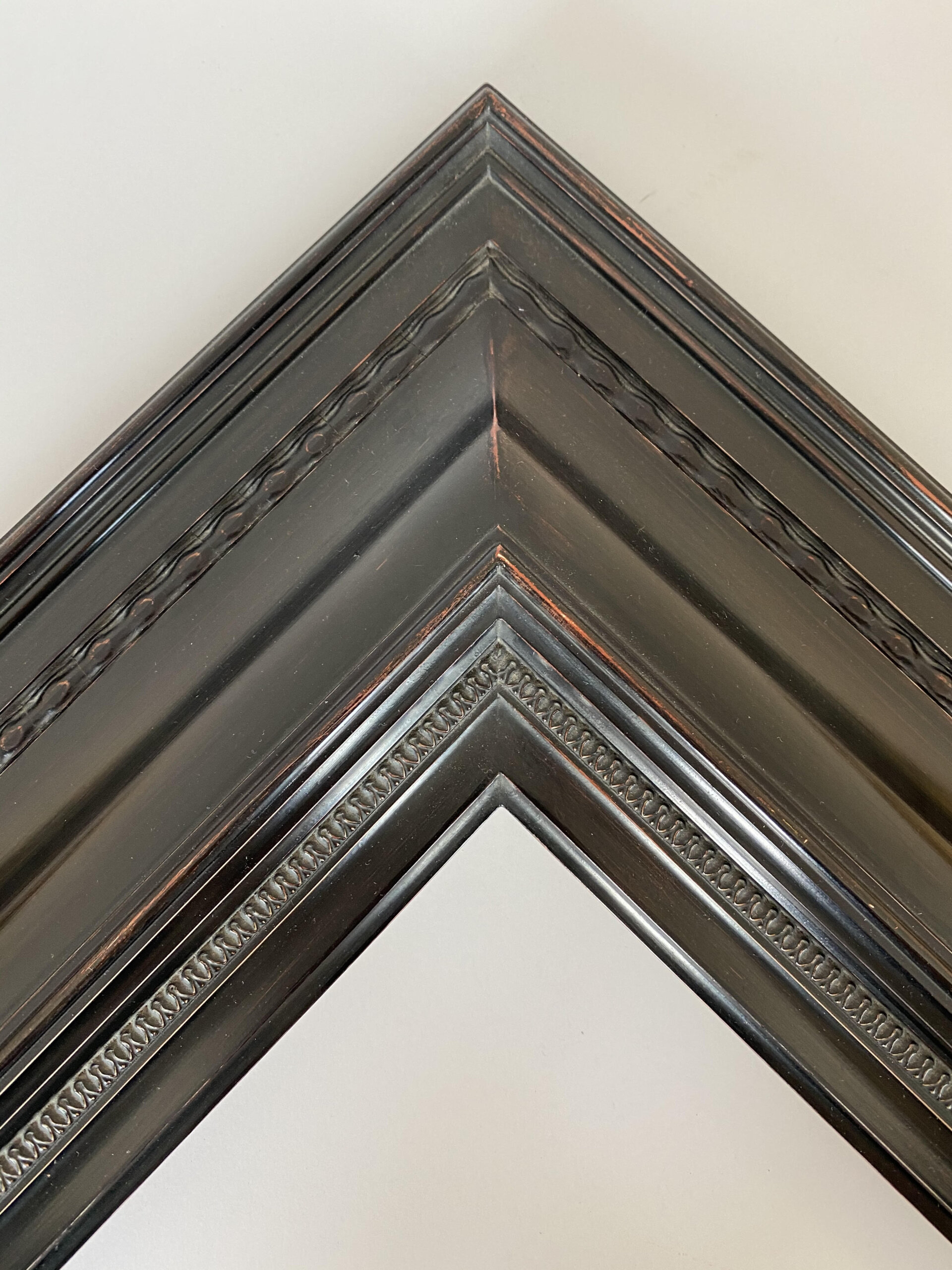 Antique Black with red rub finish on a reproduction turn of the century revival dutch frame